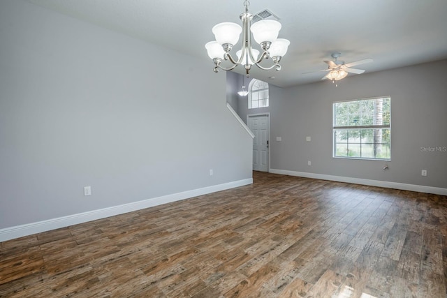 unfurnished living room with dark hardwood / wood-style floors and ceiling fan with notable chandelier