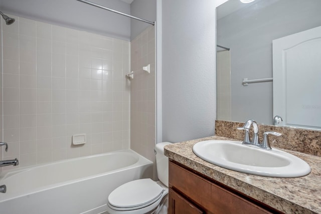 full bathroom featuring vanity, tiled shower / bath combo, and toilet