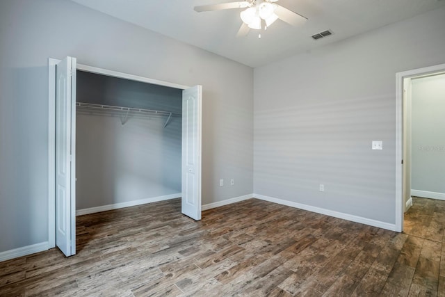 unfurnished bedroom featuring hardwood / wood-style flooring, a closet, and ceiling fan