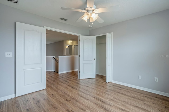 unfurnished bedroom with light wood-type flooring and ceiling fan