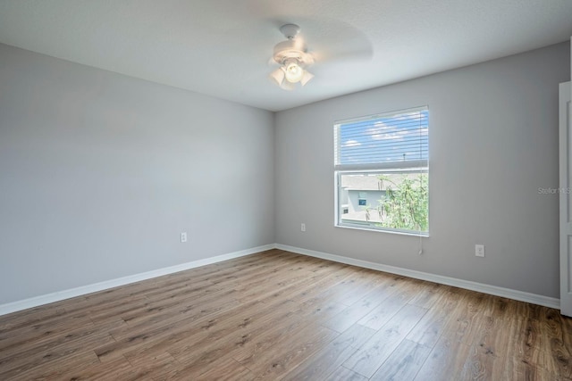 unfurnished room with hardwood / wood-style floors and ceiling fan