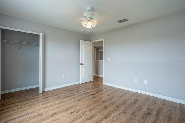 unfurnished bedroom with a closet, ceiling fan, and light wood-type flooring