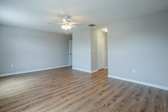 spare room with light hardwood / wood-style flooring and ceiling fan