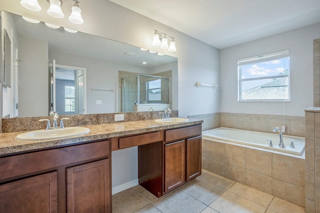 bathroom featuring tile patterned flooring, vanity, and separate shower and tub