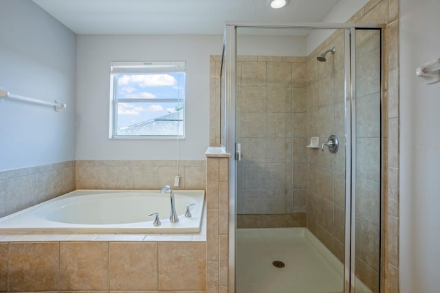 bathroom with separate shower and tub