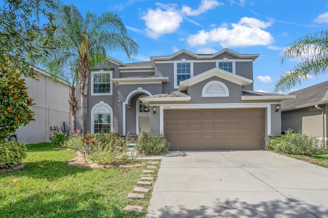 view of front of home with a garage and a front lawn