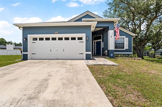 view of front of property featuring a garage and a front yard