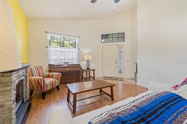 living room featuring hardwood / wood-style flooring, ceiling fan, and lofted ceiling