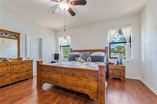 bedroom featuring dark hardwood / wood-style flooring and ceiling fan