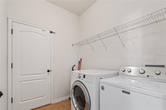 laundry room with light tile patterned floors and washer and dryer