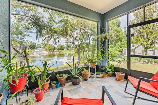 sunroom / solarium featuring a water view