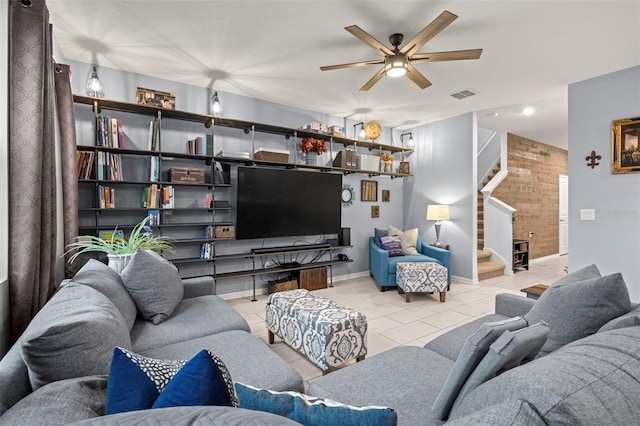 living room with ceiling fan and light tile patterned flooring