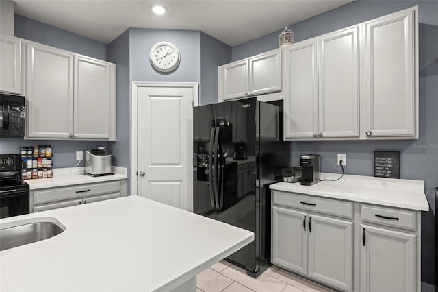 kitchen with sink and black appliances