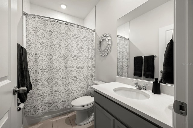 bathroom featuring tile patterned floors, vanity, toilet, and walk in shower