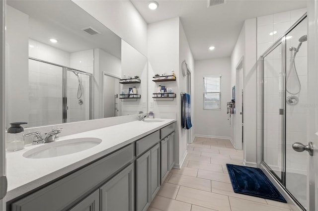 bathroom featuring vanity and a shower with shower door