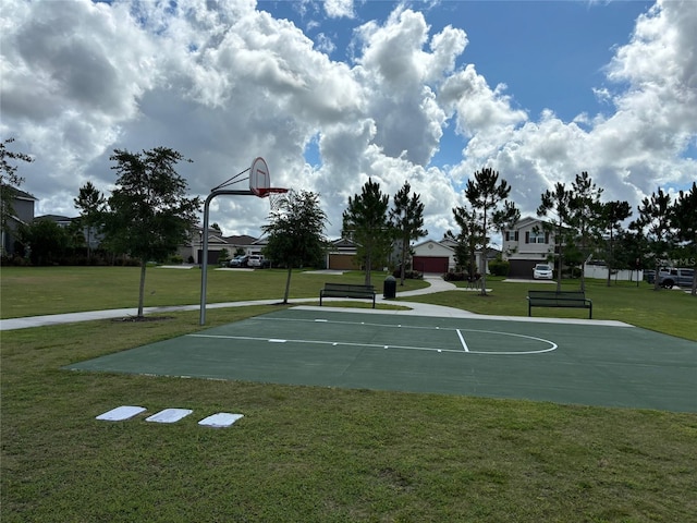 view of basketball court featuring a yard