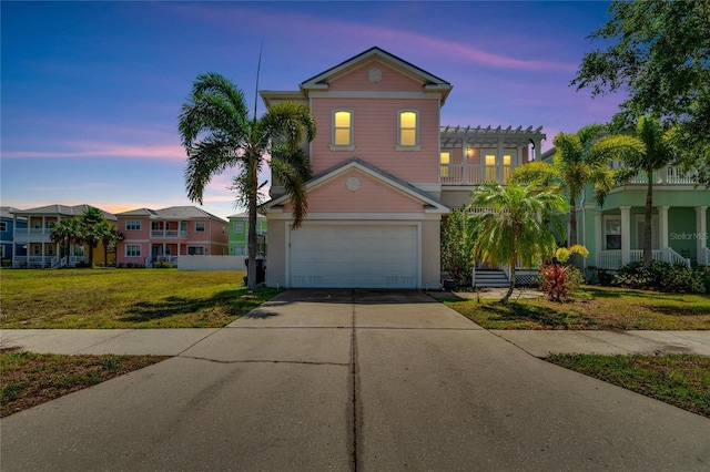 view of front of property with a lawn and a garage