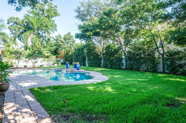 view of swimming pool with a lawn and a patio