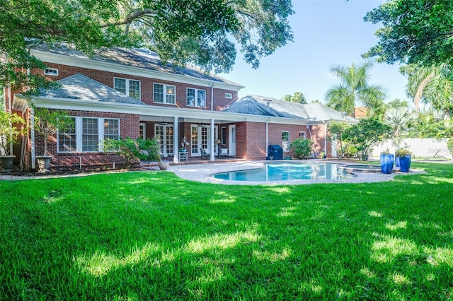 back of house featuring a yard and a patio area