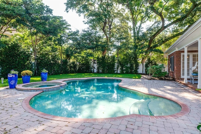 view of pool with a patio area and an in ground hot tub