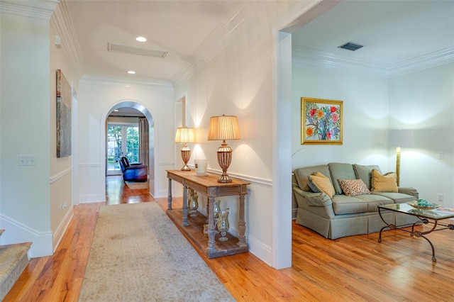 hall featuring light hardwood / wood-style floors and ornamental molding