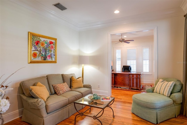 living room featuring light hardwood / wood-style flooring, ceiling fan, and crown molding