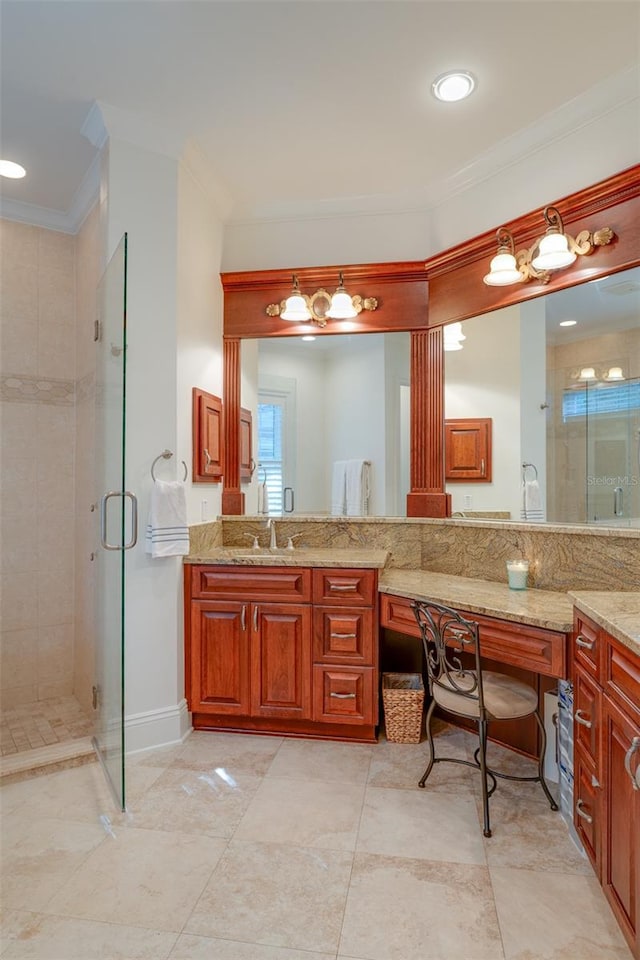 bathroom featuring vanity, a shower with shower door, and ornamental molding