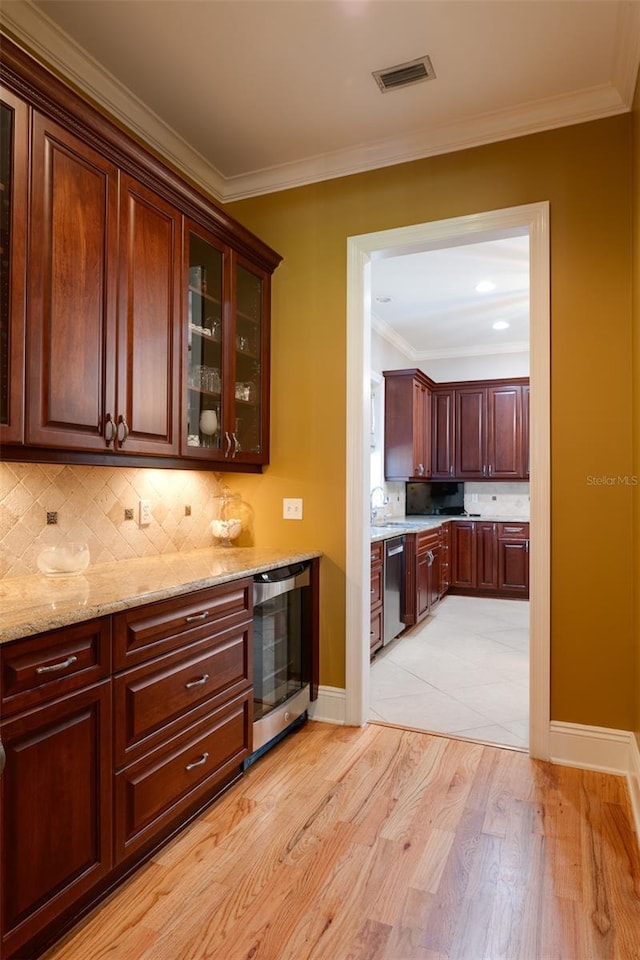 kitchen featuring decorative backsplash, light stone countertops, beverage cooler, dishwasher, and light hardwood / wood-style floors