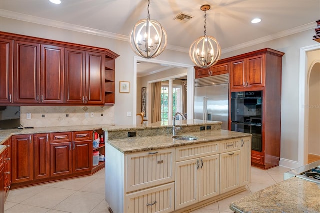 kitchen with black double oven, sink, an inviting chandelier, stainless steel built in fridge, and hanging light fixtures