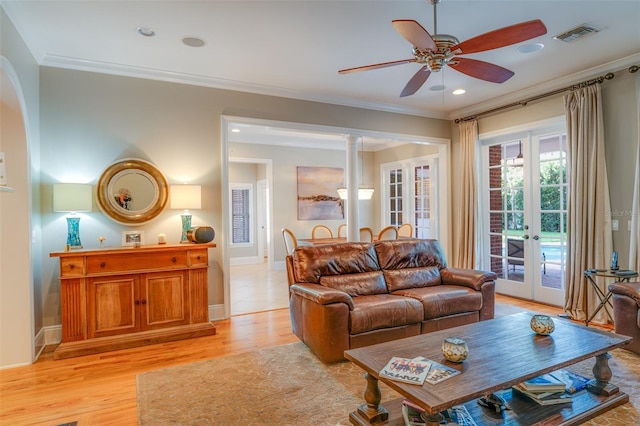 living room with french doors, light hardwood / wood-style floors, ceiling fan, and ornamental molding