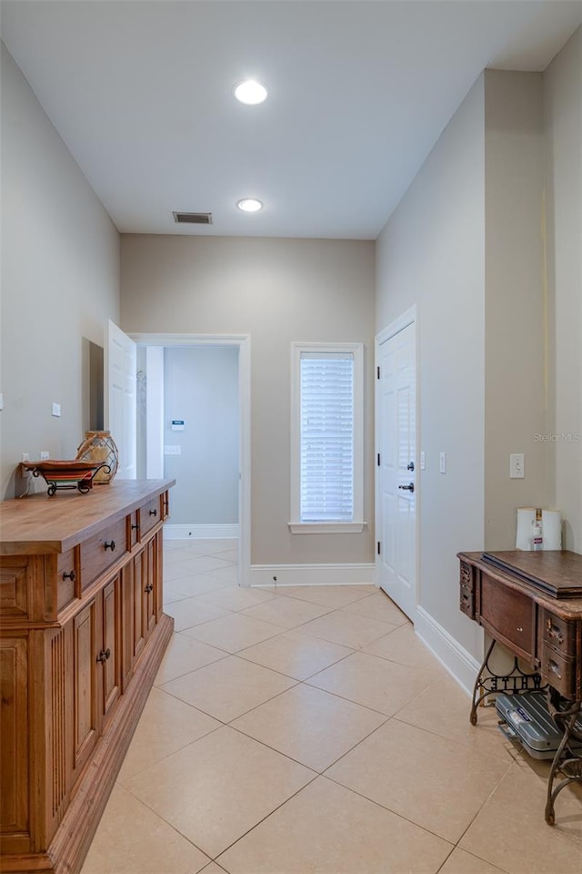 hallway featuring light tile patterned floors