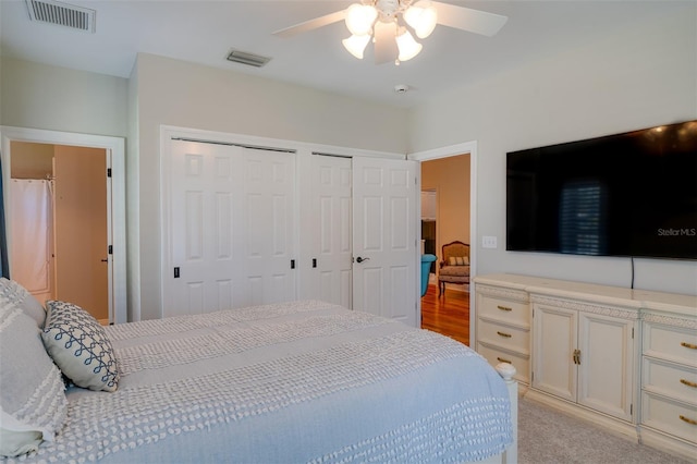 carpeted bedroom with multiple closets and ceiling fan