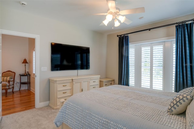 bedroom featuring light colored carpet and ceiling fan