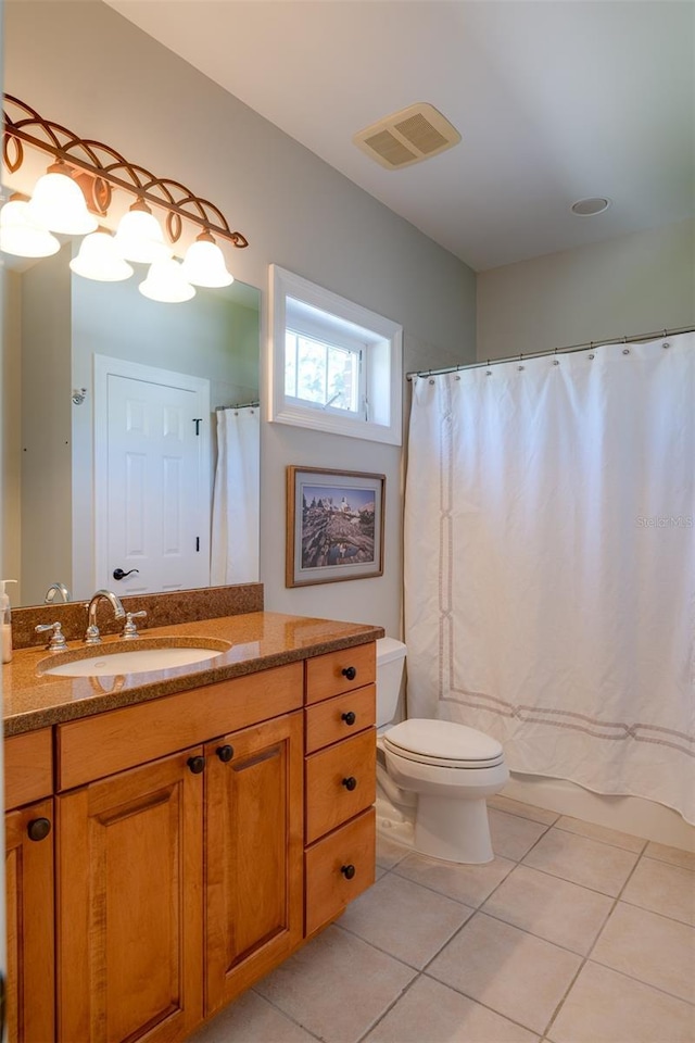 bathroom featuring tile patterned floors, vanity, curtained shower, and toilet