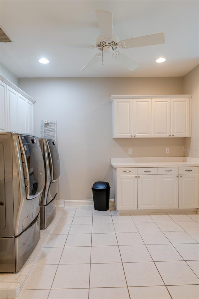 laundry area featuring washer and clothes dryer, ceiling fan, cabinets, and light tile patterned floors