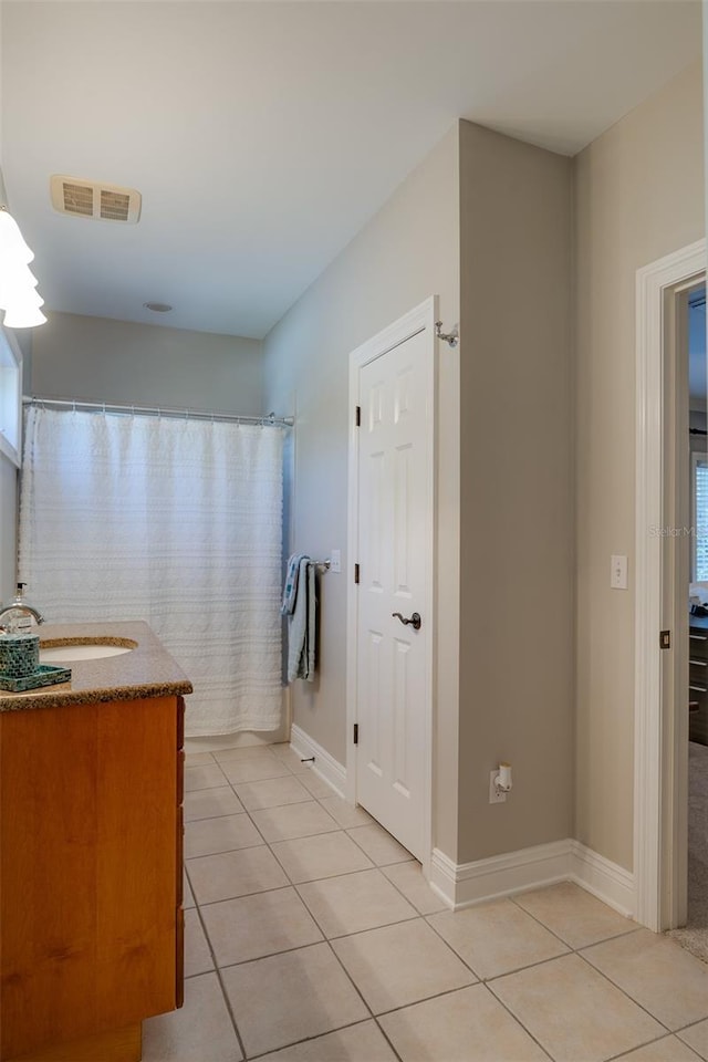 bathroom with tile patterned flooring and vanity