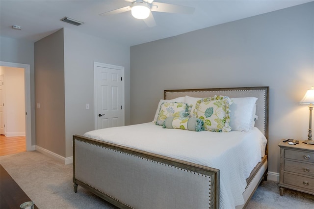 bedroom with ceiling fan and light colored carpet