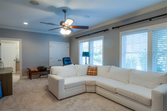 carpeted living room featuring ceiling fan and ornamental molding