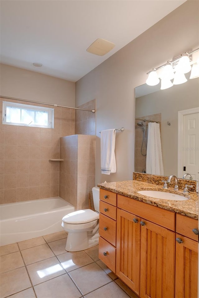 full bathroom with tile patterned floors, shower / bathtub combination with curtain, vanity, and toilet