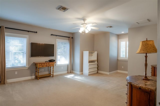 interior space featuring a wealth of natural light, light colored carpet, and ceiling fan