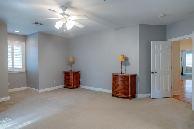 carpeted empty room featuring ceiling fan