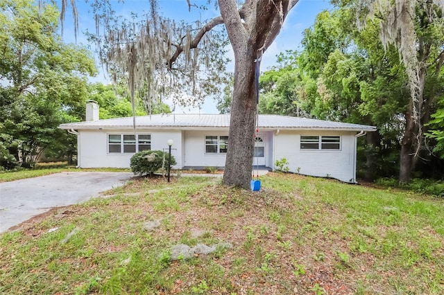 rear view of property with a yard