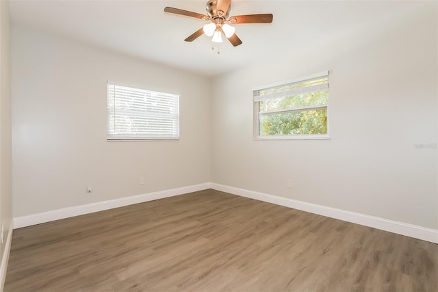 spare room featuring ceiling fan and dark wood-type flooring