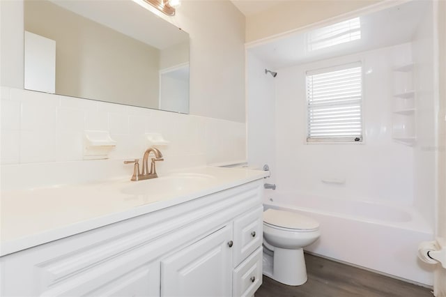 full bathroom with shower / bath combination, tasteful backsplash, vanity, hardwood / wood-style floors, and toilet