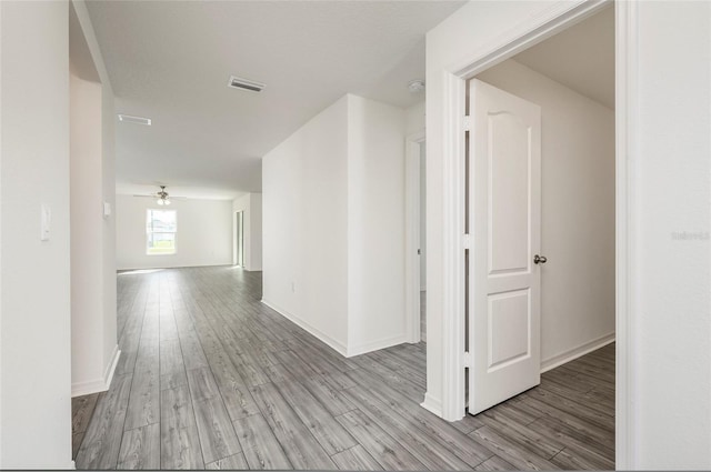 hallway with light hardwood / wood-style flooring