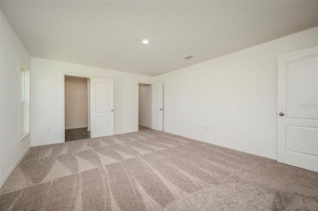 unfurnished bedroom featuring light colored carpet