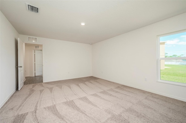 spare room featuring light colored carpet