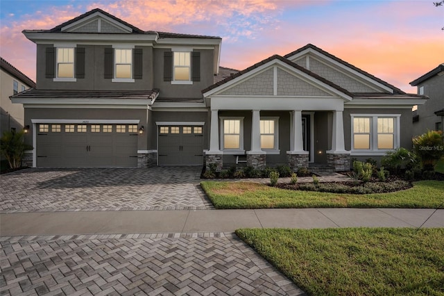 view of front of property featuring a porch and a garage