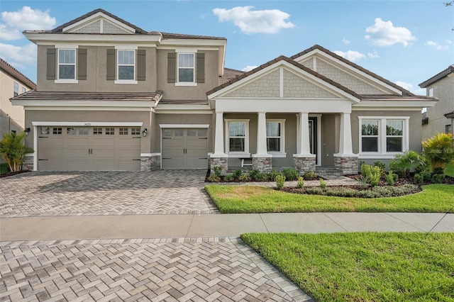 view of front of property with covered porch and a garage