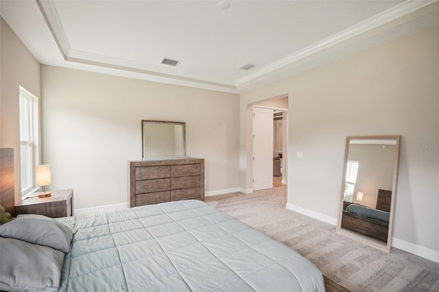 carpeted bedroom with a tray ceiling and crown molding